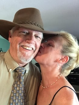 Middle aged woman kissing a man on the cheek